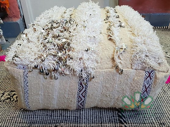 Kilim Moroccan poufs and ottomans made from rug and wool material, featuring vibrant patterns and traditional craftsmanship for stylish decor.