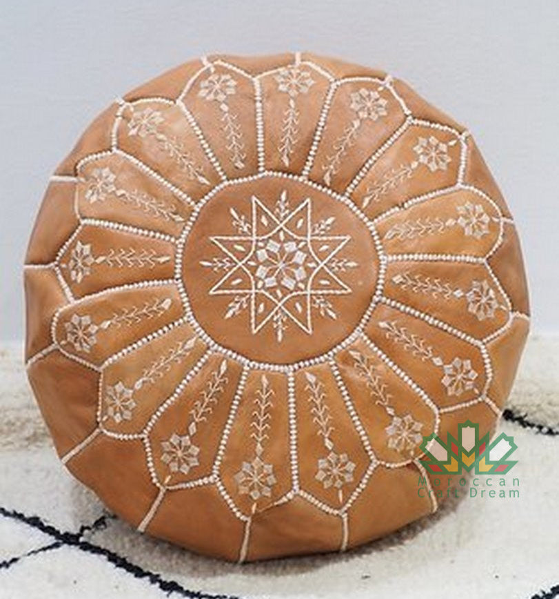 Handcrafted Moroccan leather poufs, ottomans and footstool in natural tones, featuring traditional stitching and soft, durable materials.