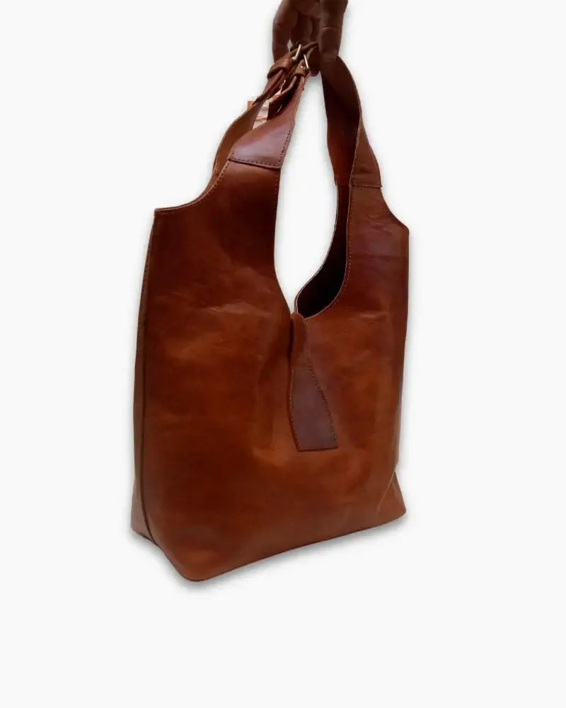 Handcrafted Moroccan leather bag purse in natural brown, featuring traditional stitching and a minimalist design, made from eco-friendly materials