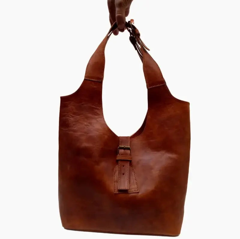 Handcrafted Moroccan leather bag purse in natural brown, featuring traditional stitching and a minimalist design, made from eco-friendly materials