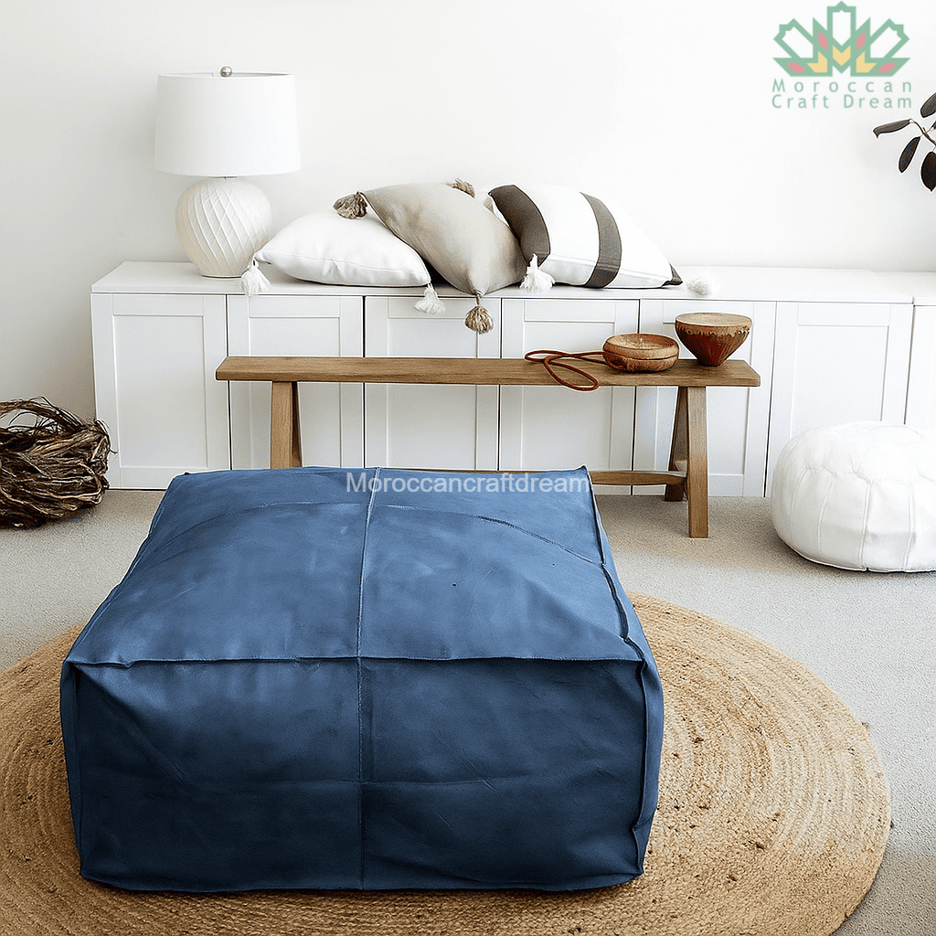 Blue bean bag chair in a living room setting with a wooden bench and decorative items.