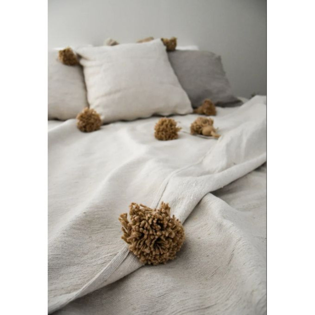 handcrafted white moroccan blanket with pompoms