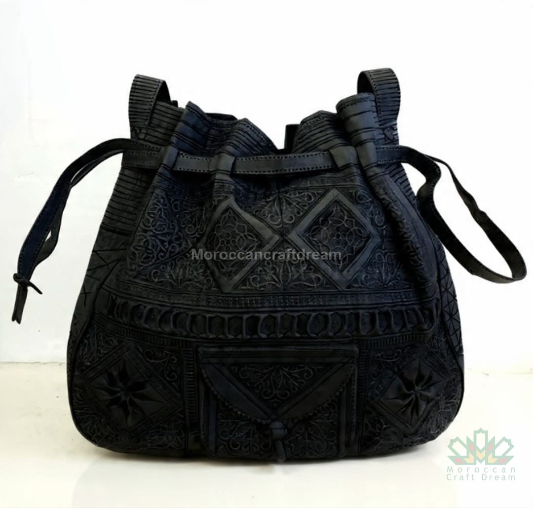 Black embroidered bag with geometric patterns on a white background