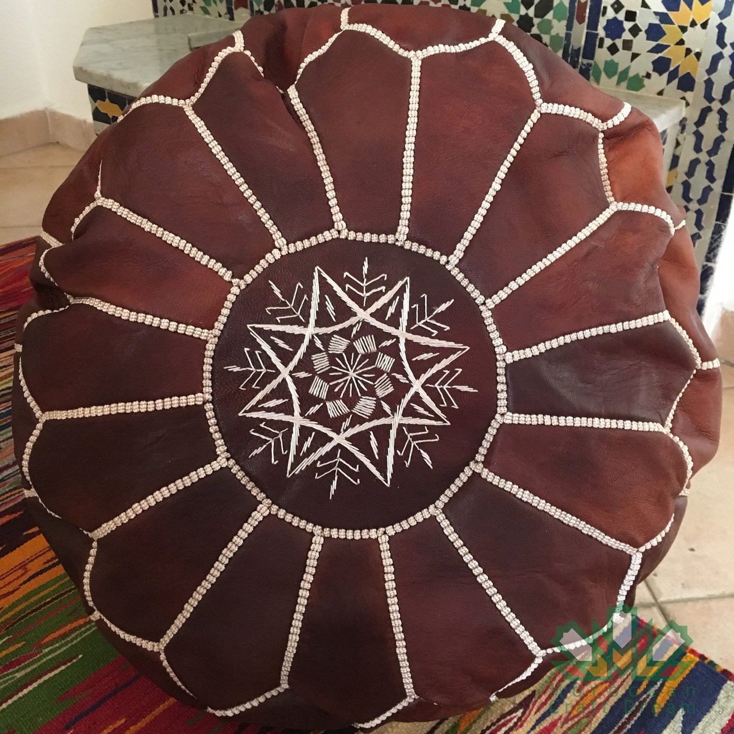 Elegant and functional Moroccan chocolate brown leather pouf ottoman in a classic design, suitable for modern and traditional interiors.