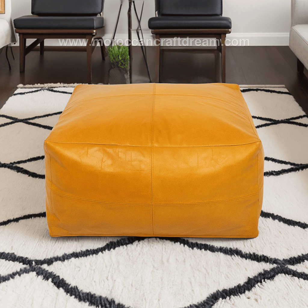 Mustard leather ottoman on a patterned rug with 'Moroccan Craft Dream' branding.