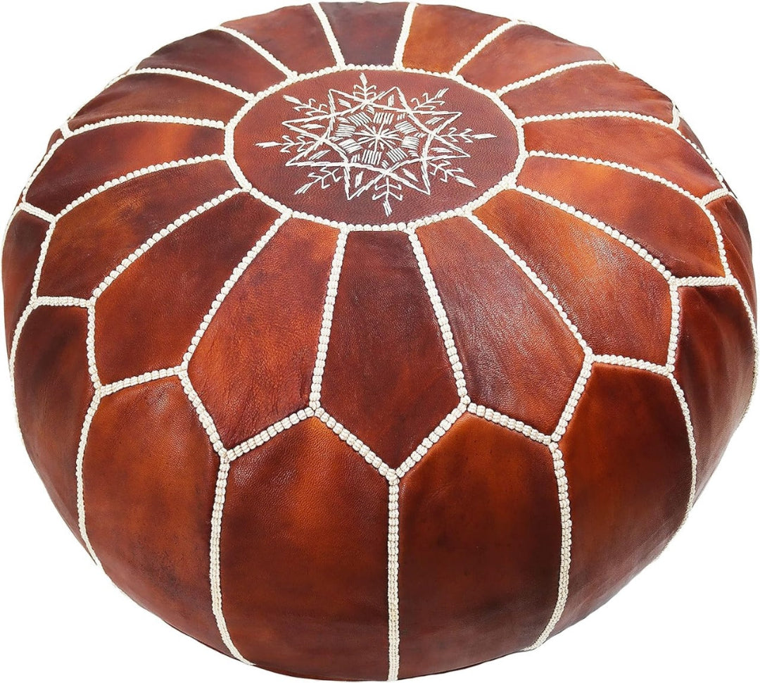 Moroccancraftdream tan leather pouf ottoman with geometric patterns, offering versatile use as a seat, footrest, or coffee table.