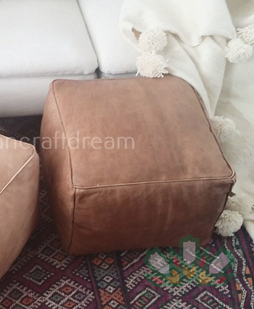Handcrafted leather Moroccan poufs, ottomans and footstool in natural tones, featuring traditional stitching and soft, durable materials.