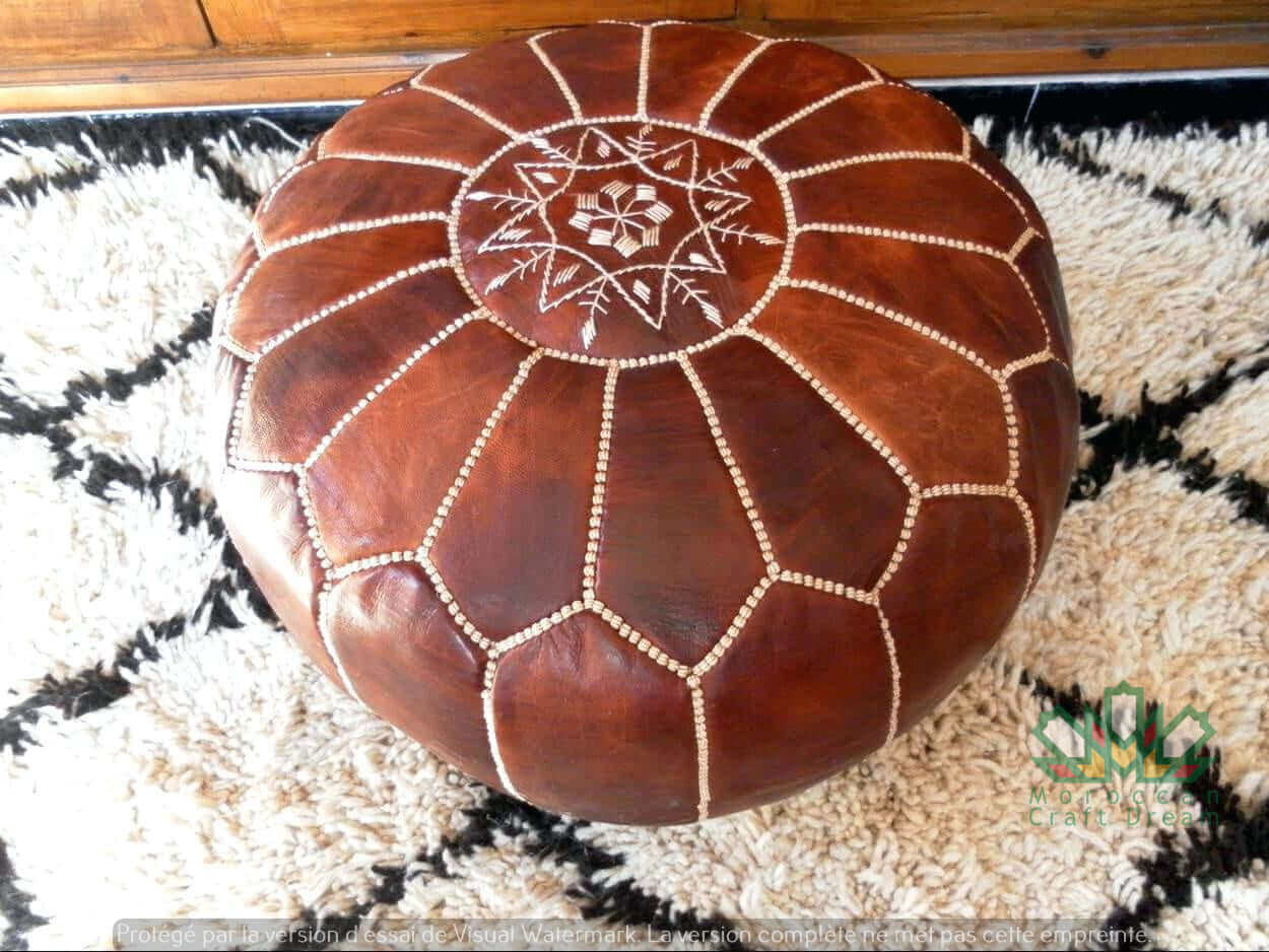 Handcrafted Moroccan leather poufs, ottomans and footstool in natural tones, featuring traditional stitching and soft, durable materials.