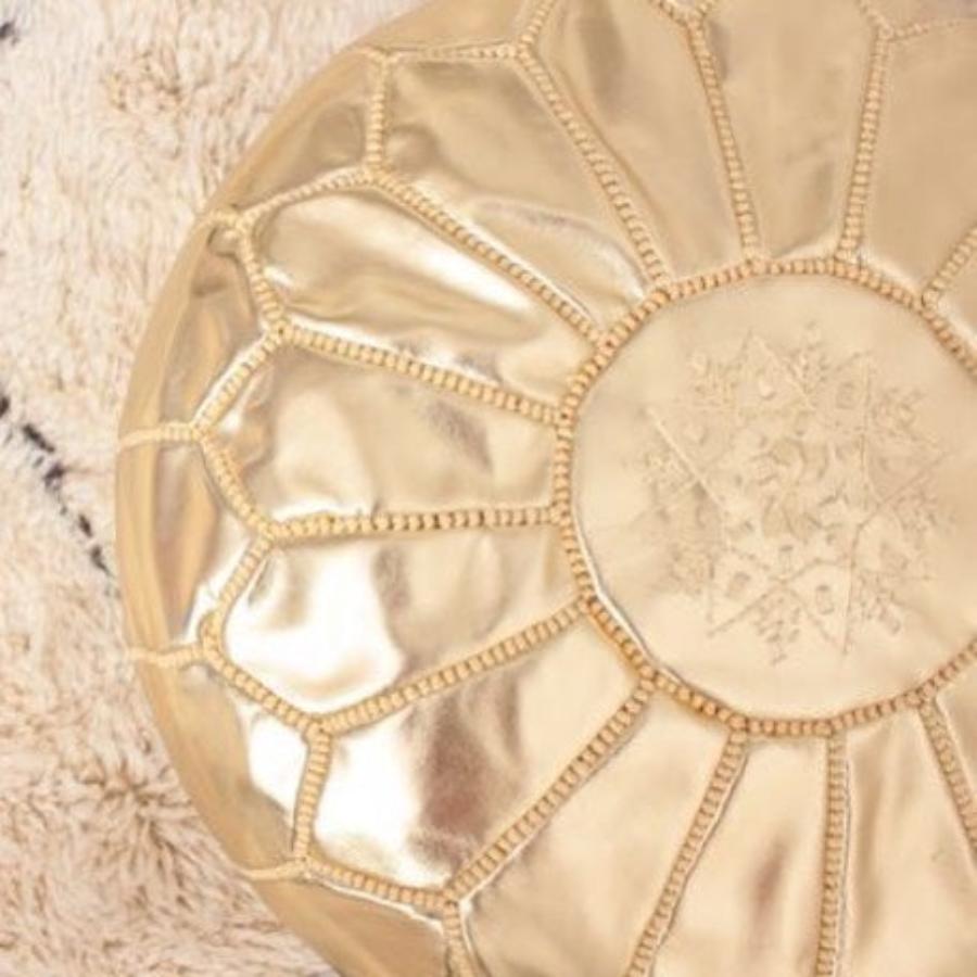 Gold Handcrafted Moroccan leather pouf for living room decor, blending comfort with authentic Moroccan style.