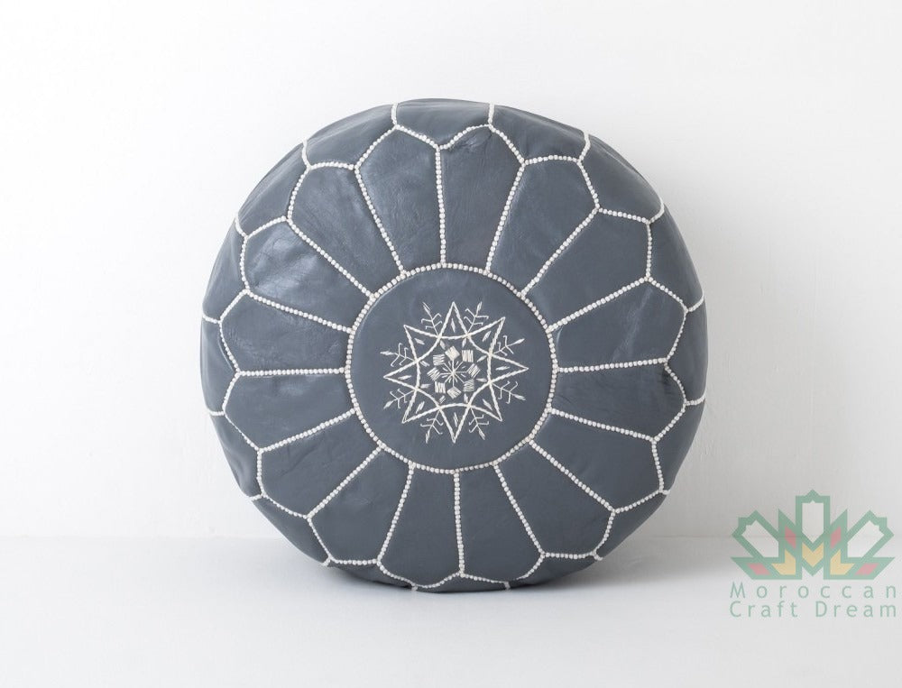Grey Handmade Moroccan leather pouf, perfect for use as a coffee table or versatile seating option.