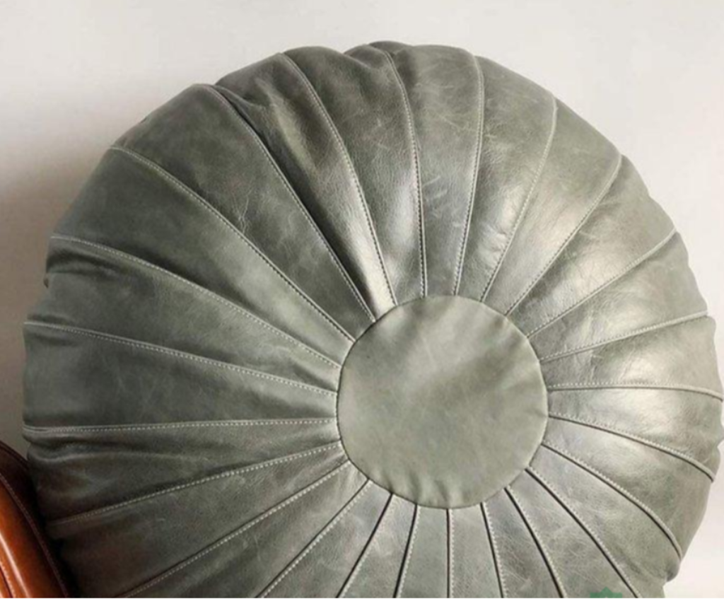 Gray Round Moroccan leather ottoman featuring durable craftsmanship, suitable for daily use as seating or footrest.