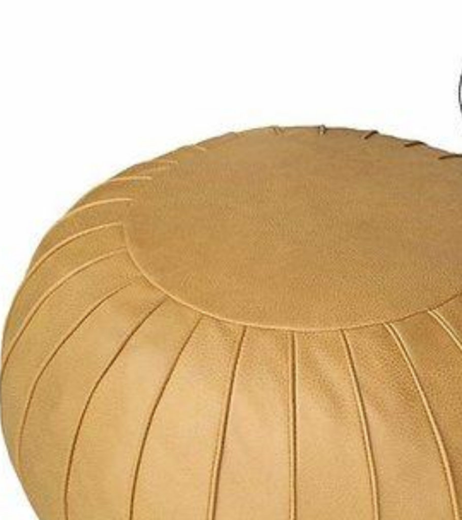 Mustarrd Round leather moroccan pouf used as a coffee table, handcrafted with durable materials and traditional stitching in natural tones.