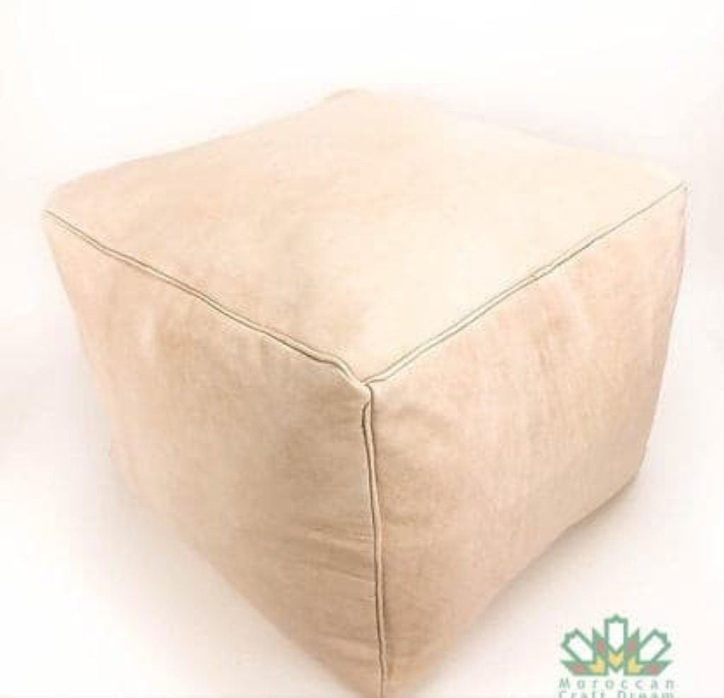 Natural light Handcrafted leather Moroccan poufs, ottomans and footstool in natural tones, featuring traditional stitching and soft, durable materials.