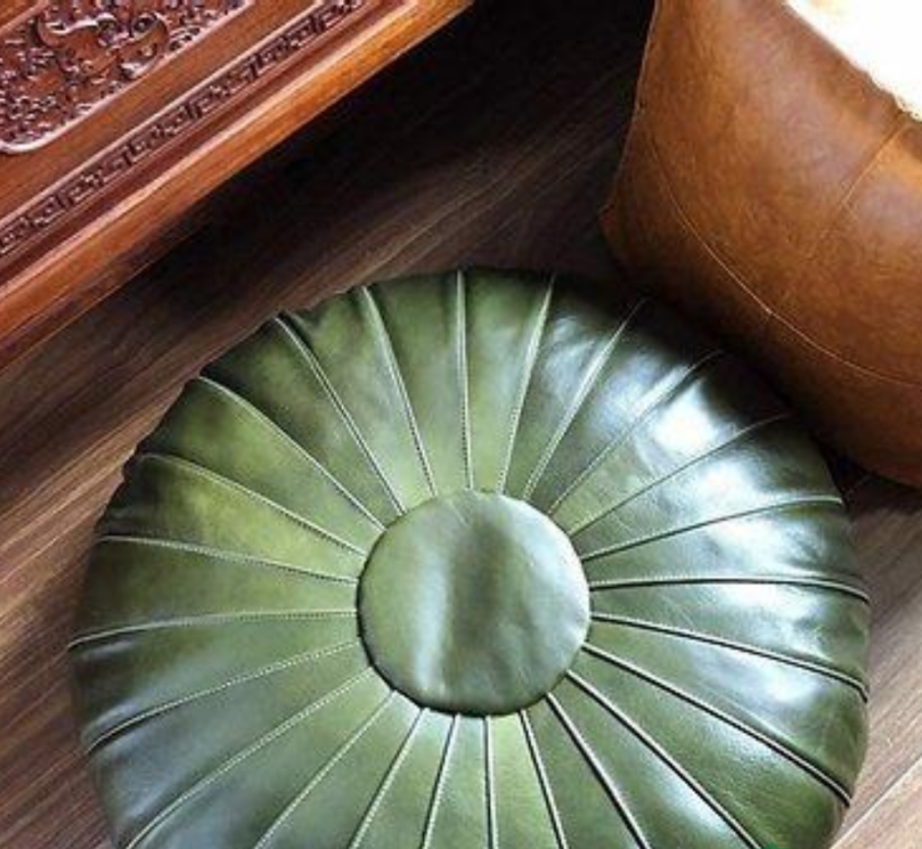Green Round classy Handcrafted Moroccan leather pouf, offering versatility and style as a seating option or decorative coffee table.