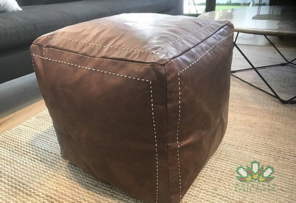 Handcrafted Moroccan leather poufs, ottomans and footstool in natural tones, featuring traditional stitching and soft, durable materials.