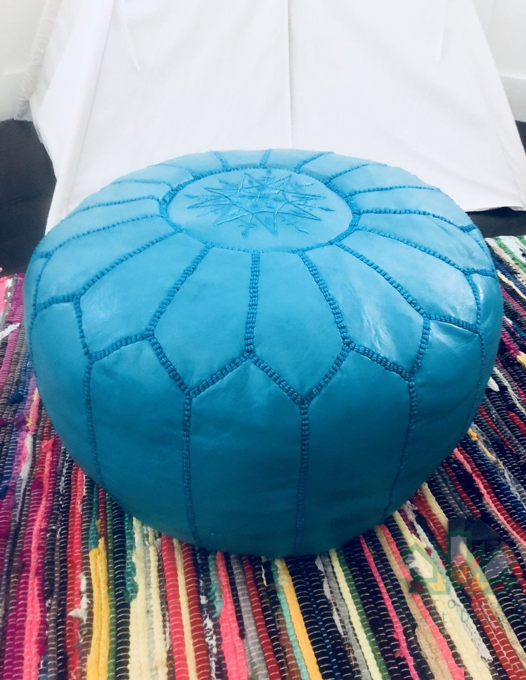 Handcrafted Moroccan leather poufs, ottomans and footstool in natural tones, featuring traditional stitching and soft, durable materials.