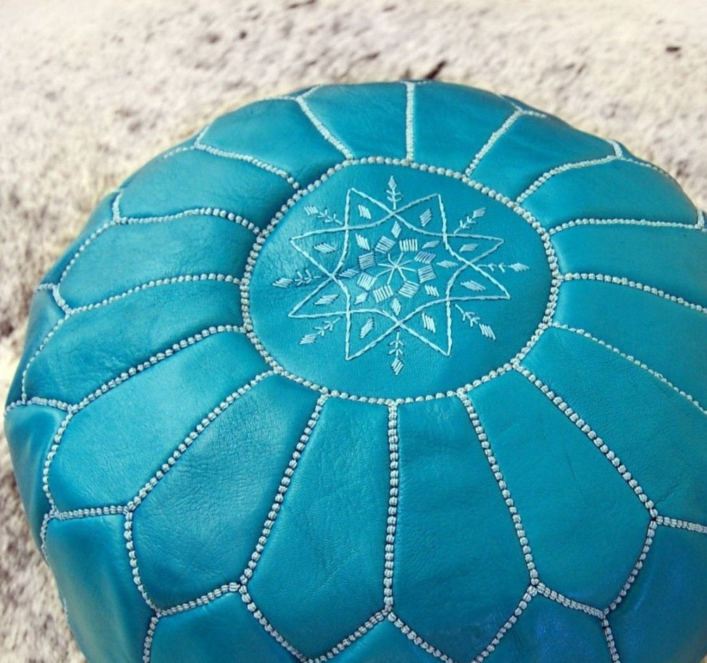 Handcrafted Moroccan leather poufs, ottomans and footstool in natural tones, featuring traditional stitching and soft, durable materials.