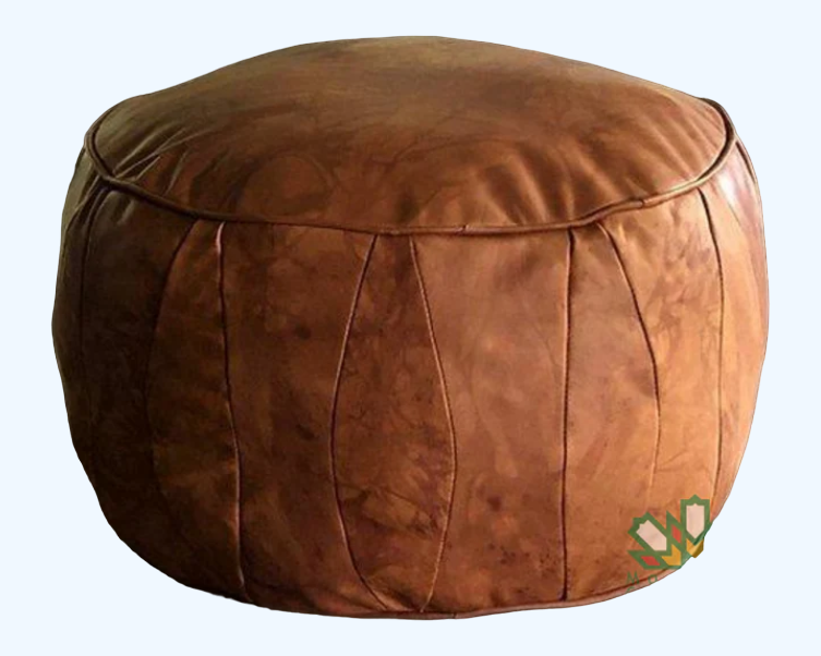 White handmade round Moroccan pouf ottoman in genuine leather, perfect for use as a versatile coffee table or footrest. This Moroccan leather ottoman enhances living room decor with its elegant design and multifunctional use.