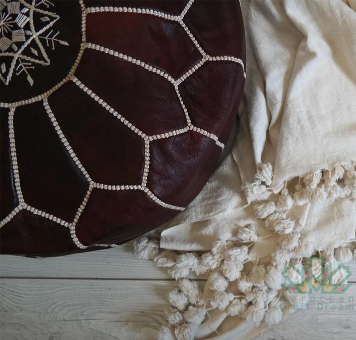 Handcrafted Moroccan leather poufs, ottomans and footstool in natural tones, featuring traditional stitching and soft, durable materials.