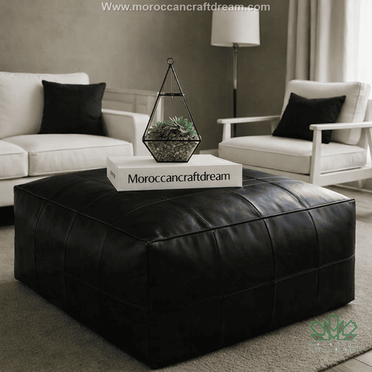 Black leather ottoman coffee table in a modern living room with 'Morocancraftdream' branding.