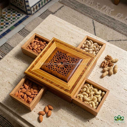 Wooden tray with compartments filled with nuts on a textured surface