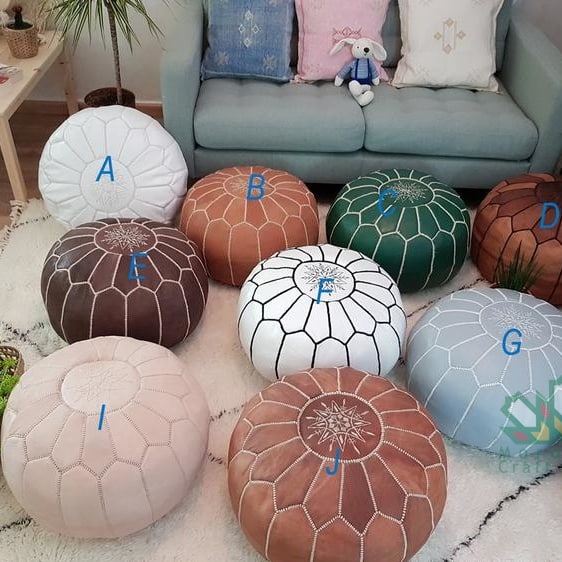 Handcrafted Moroccan leather poufs, ottomans and footstool in natural tones, featuring traditional stitching and soft, durable materials.