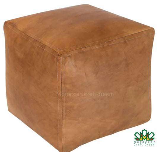 Light caramel leather Handcrafted Moroccan leather poufs, ottomans and footstool in natural tones, featuring traditional stitching and soft, durable materials.