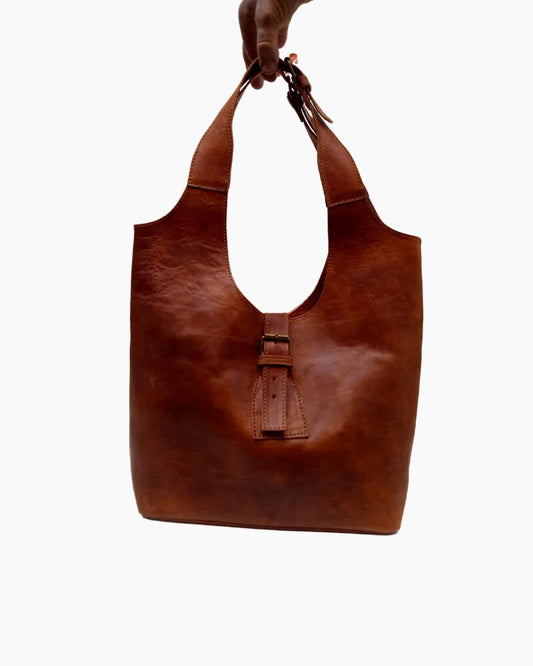 Handcrafted Moroccan leather bag purse in natural brown, featuring traditional stitching and a minimalist design, made from eco-friendly materials