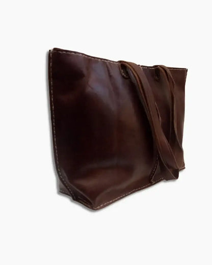 Handcrafted Moroccan leather bag purse in natural brown, featuring traditional stitching and a minimalist design, made from eco-friendly materials