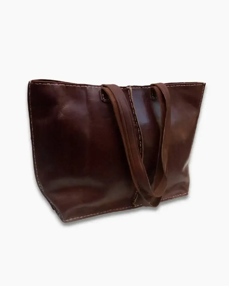 Handcrafted Moroccan leather bag purse in natural brown, featuring traditional stitching and a minimalist design, made from eco-friendly materials