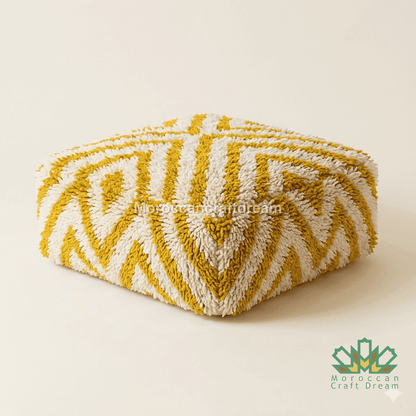 Yellow and white patterned ottoman with dimensions on a beige background