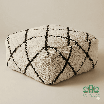 Triangular ottoman with black and white geometric pattern on a white background