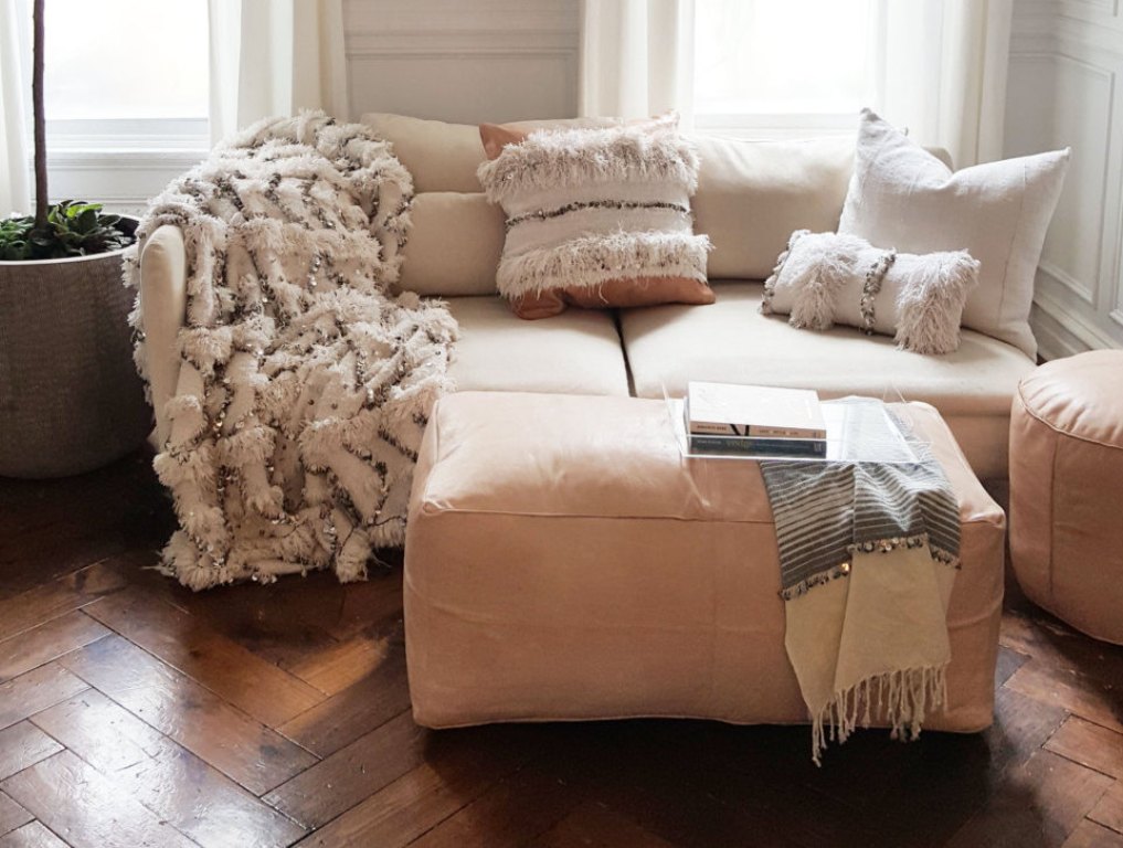 Large nude Handcrafted Moroccan leather pouf, offering versatility and style as a seating option or decorative coffee table.