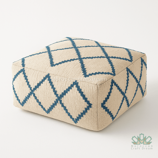 Beige ottoman with blue geometric pattern on a white background