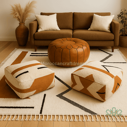 Brown sofa with patterned ottomans on a geometric rug in a living room setting.