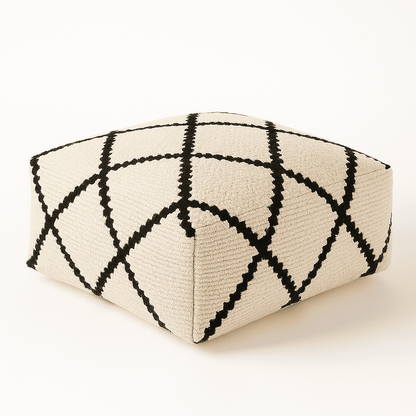 Triangular ottoman with black and white geometric pattern on a white background