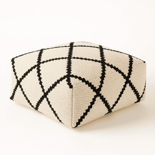 Triangular ottoman with black and white geometric pattern on a white background