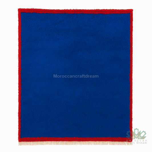 Blue fabric with red border and fringe on a white background