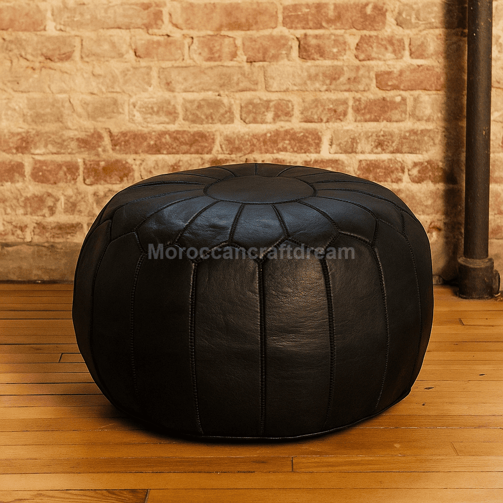Black leather ottoman against a brick wall
