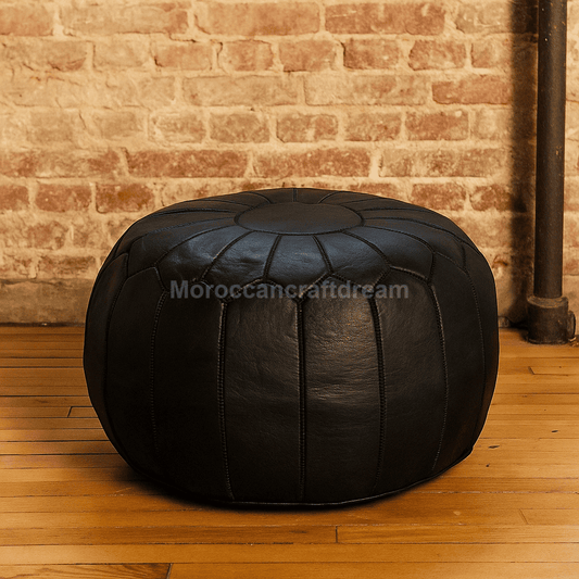 Black leather ottoman against a brick wall