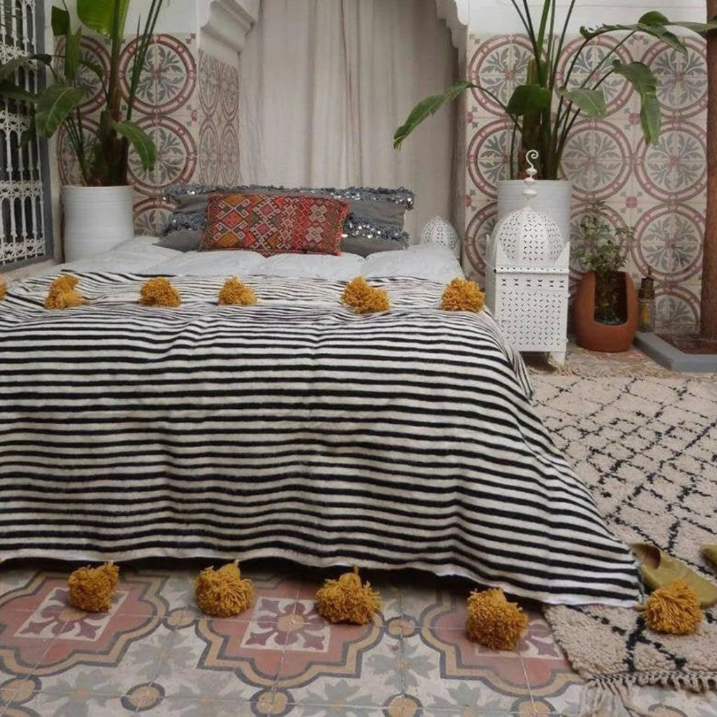 blanket black with yellow pompoms