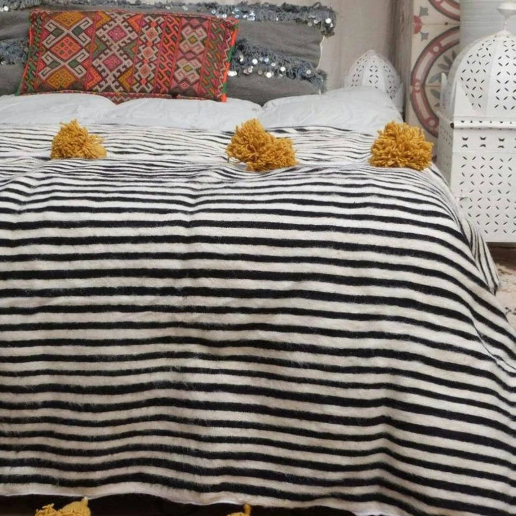 a handmade black white blanket in a room