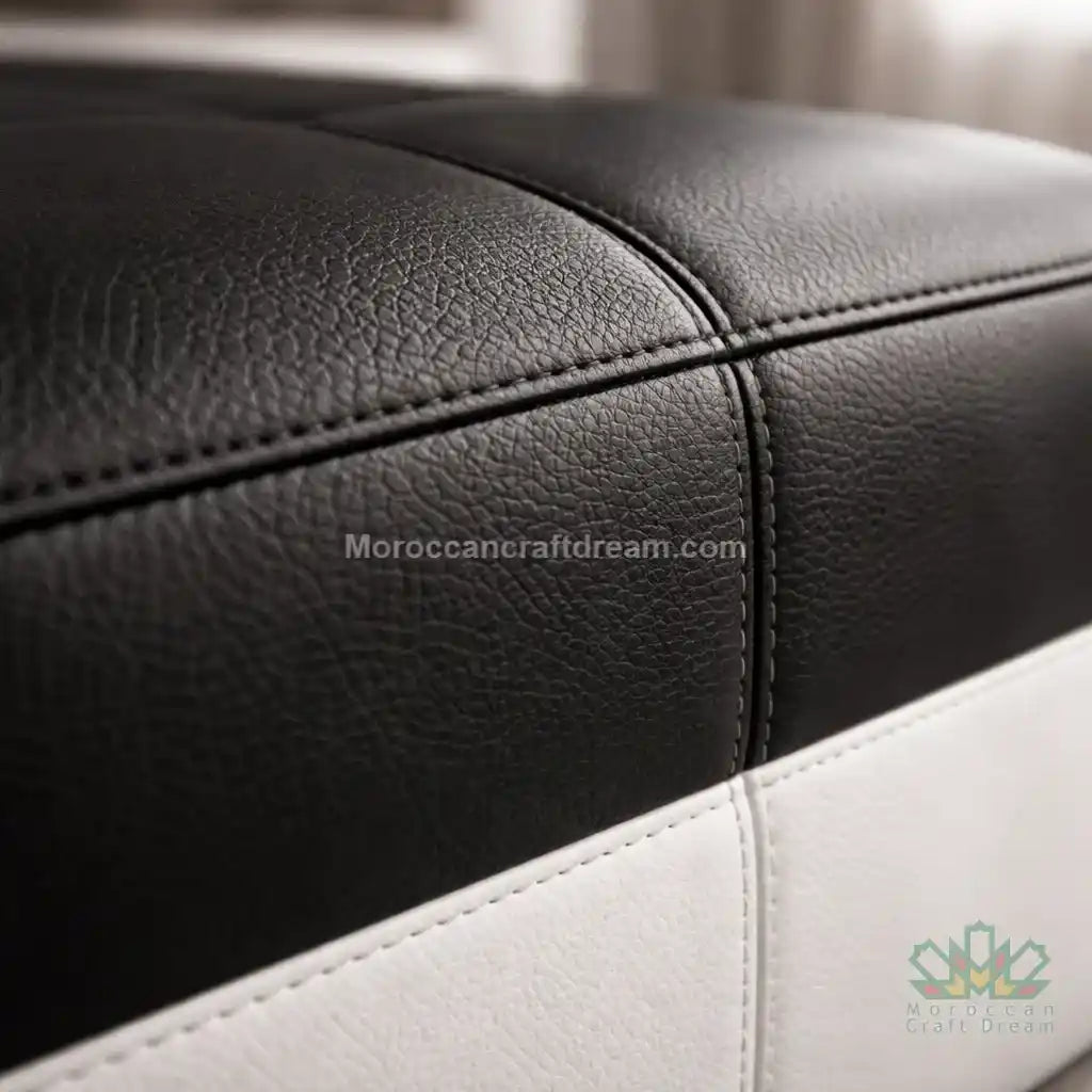 Close-up of black and white leather furniture with 'MoroccanCraftDream.com' branding.