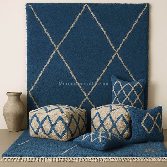 Blue geometric patterned rug with matching pillows and a vase on a neutral background