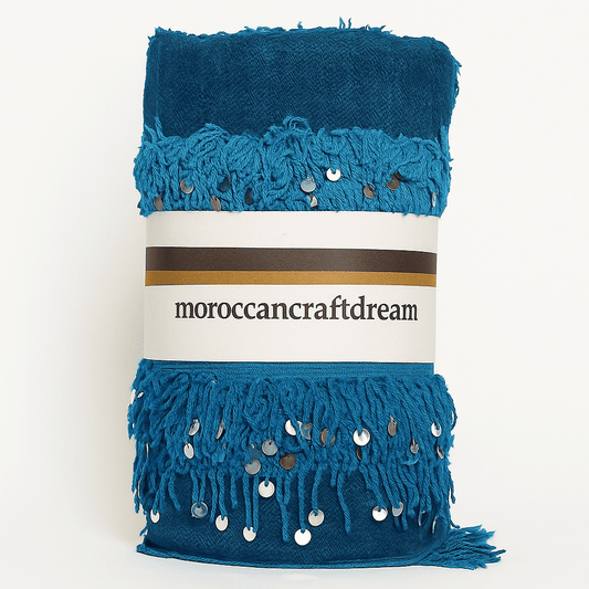 Blue fabric with fringe and sequins on a white background, featuring 'moroccancraftdream' label.