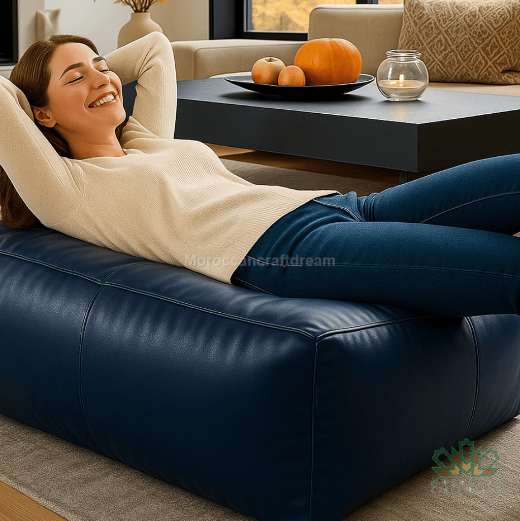 Woman relaxing on a blue sofa in a living room with a coffee table and decorative items.