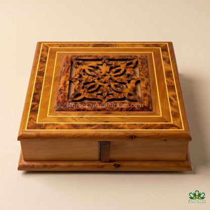 Traditional Moroccan Thuya wood craftsmanship in a minimalist boutique setting.