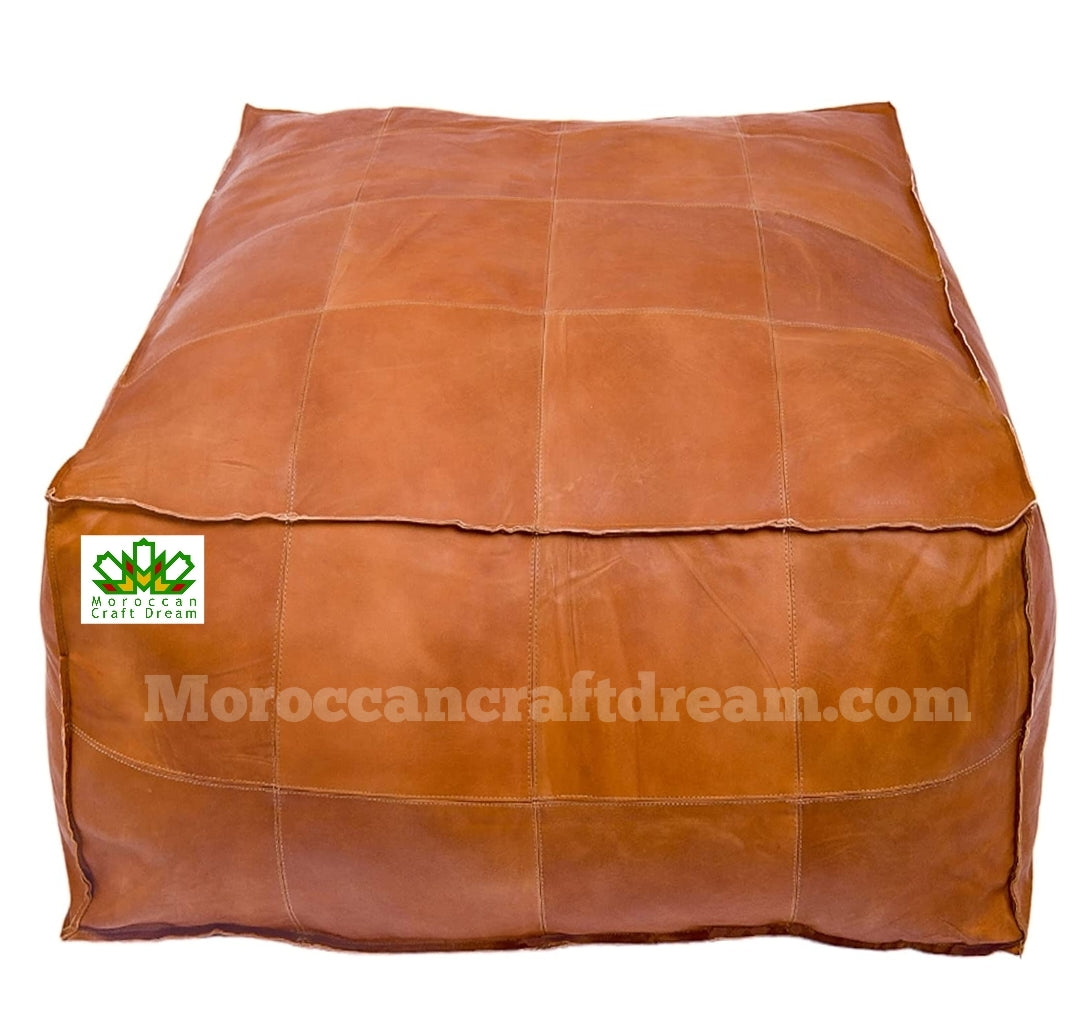 Large Caramel square leather coffee table ottoman, a blend of style and functionality for spacious living areas.