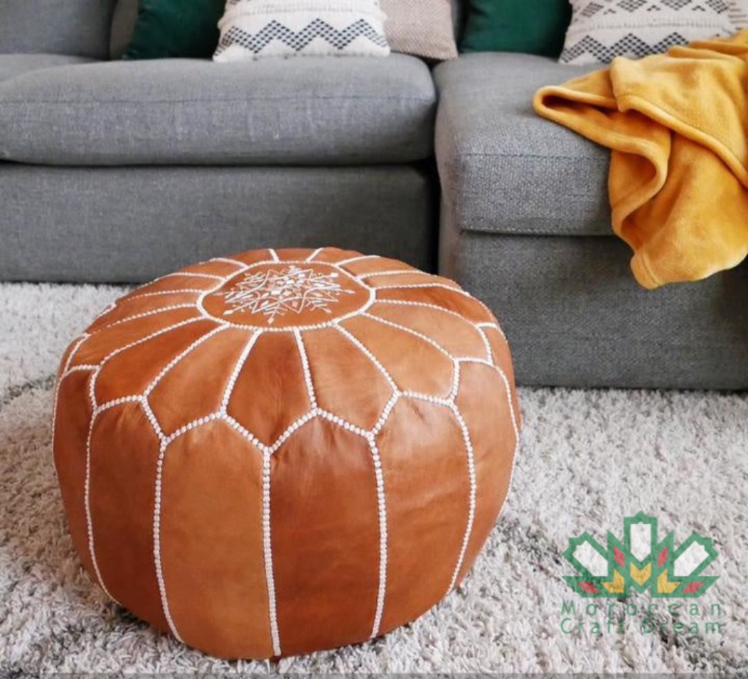 Caramel Handcrafted Moroccan leather pouf ottoman, versatile as a coffee table or foot stool, made from high-quality leather for a stylish and functional addition to any room decor.