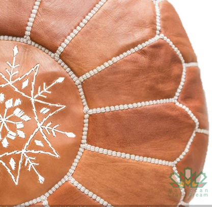 Genuine leather caramel Moroccan pouf ottoman, handcrafted with traditional techniques for a stylish addition to any space.